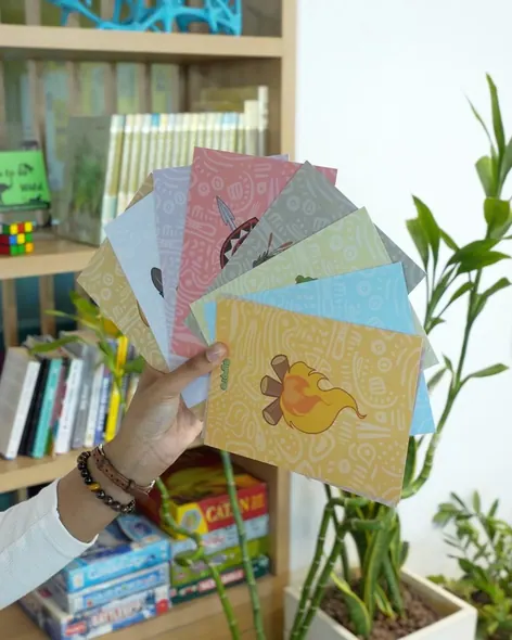 A fan of colourful Dupoto icon cards, with the Campfire card at the front